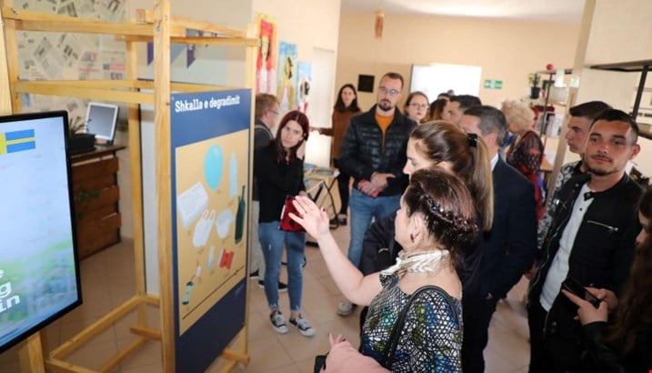 Photo of Ambassodor Elsa Håsatd pointing at the exhibition posters